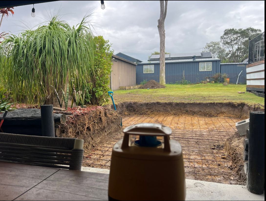 Backyard lawn marked out before the patio dig