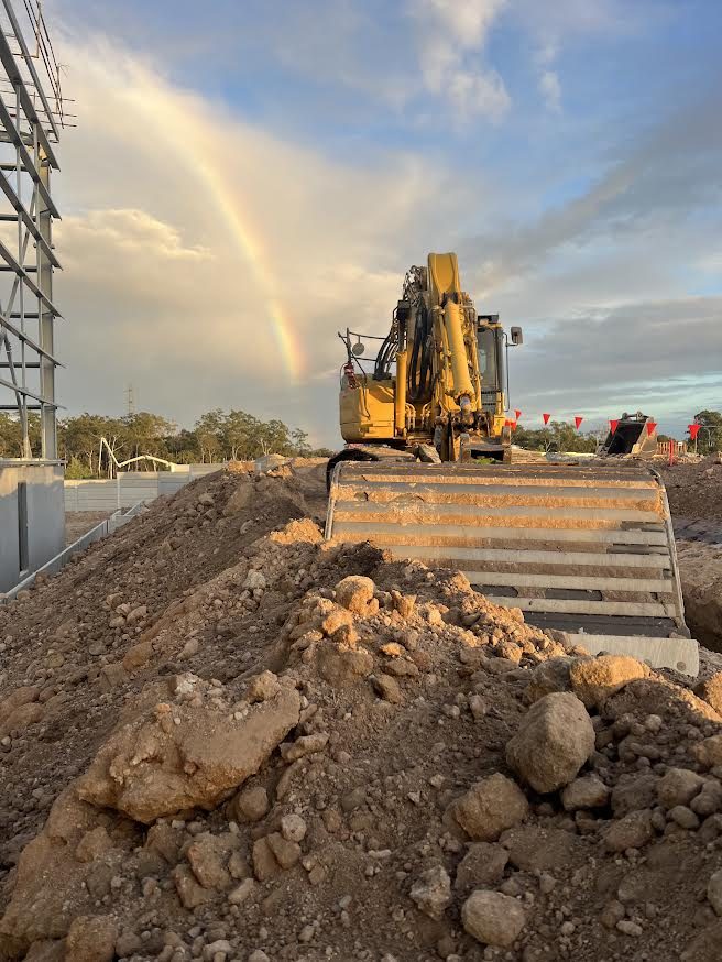 Excavator on bulk earthworks at a commercial site